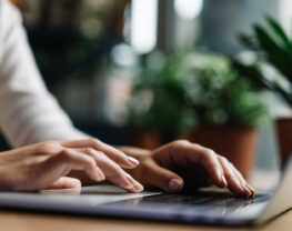 hands typing on keyboard