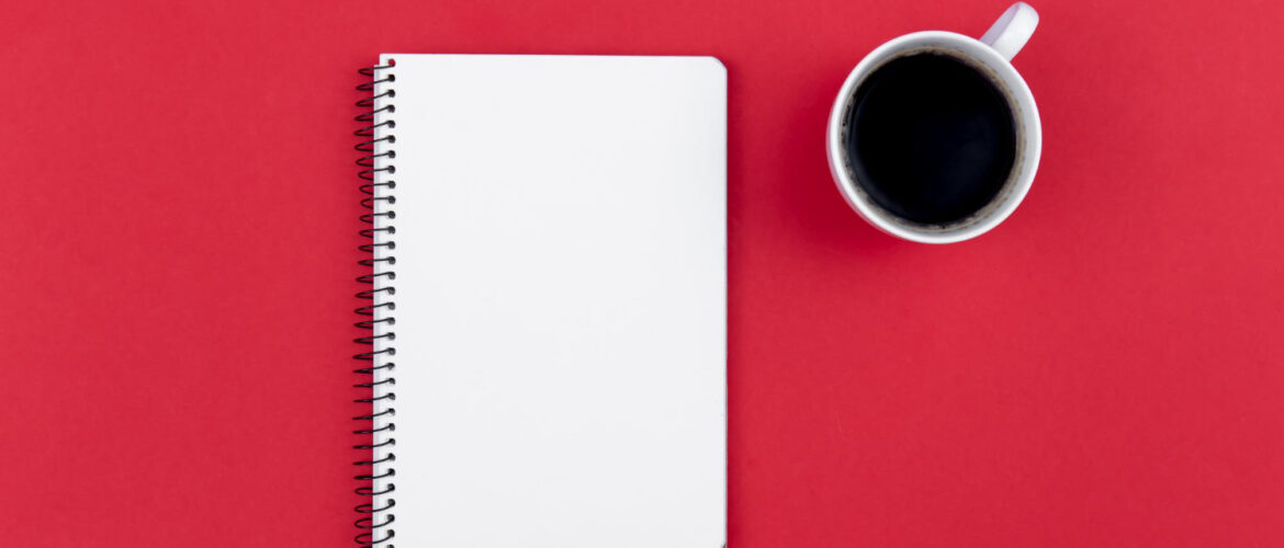 Blank notepad and coffee cup on the red background