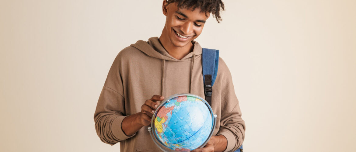 Positive young man with globe in his hands