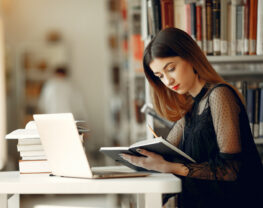 Girl student studies at the library.