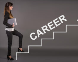 A business woman is climbing the stairs of career ladder