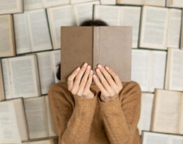Top view of a girl lying on open books